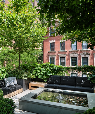 A stone water feature in a rooftop NYC garden.