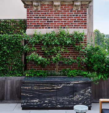 Stone clad cabinetry in front of wood clad planters.