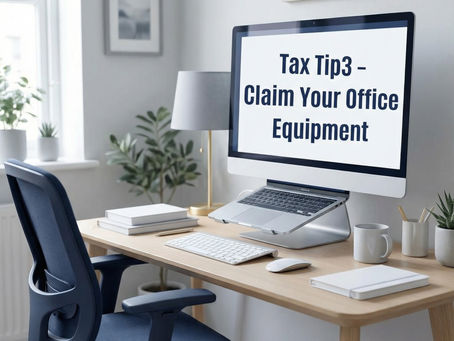 Home office with a large monitor displaying "Tax Tip 3 – Claim Your Office Equipment." Blue chair, light wood desk, books, lamp, and window view.