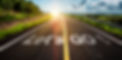 The word let's go written on highway road in the middle of empty asphalt road at beautifu