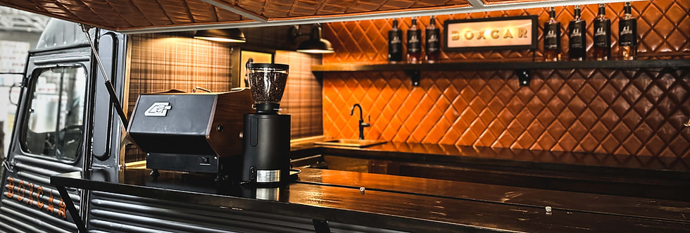 Coffee truck bar top with syrups on the back wall.