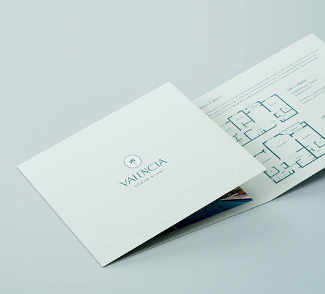 Valencia custom print design trifold with an overhead shot showing the trifold slightly opened with floorplans visible