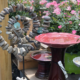 ceramic bird baths and stone statuary on display