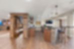 Full wet bar with walk in wine cellar and stone bar with barstools