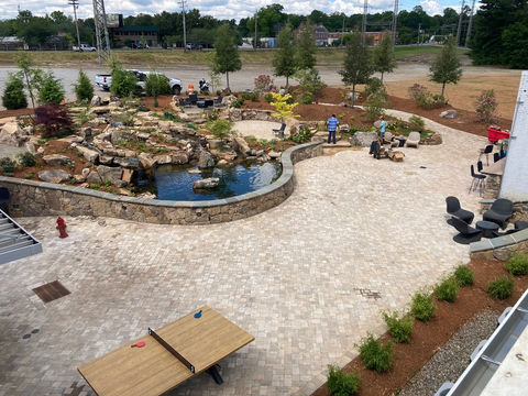 Landscaping companies in Spartanburg SC creating outdoor living space with patio and water feature