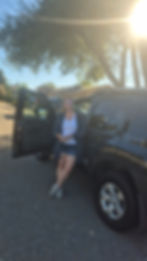 Rebecca Massek standing in front of her car