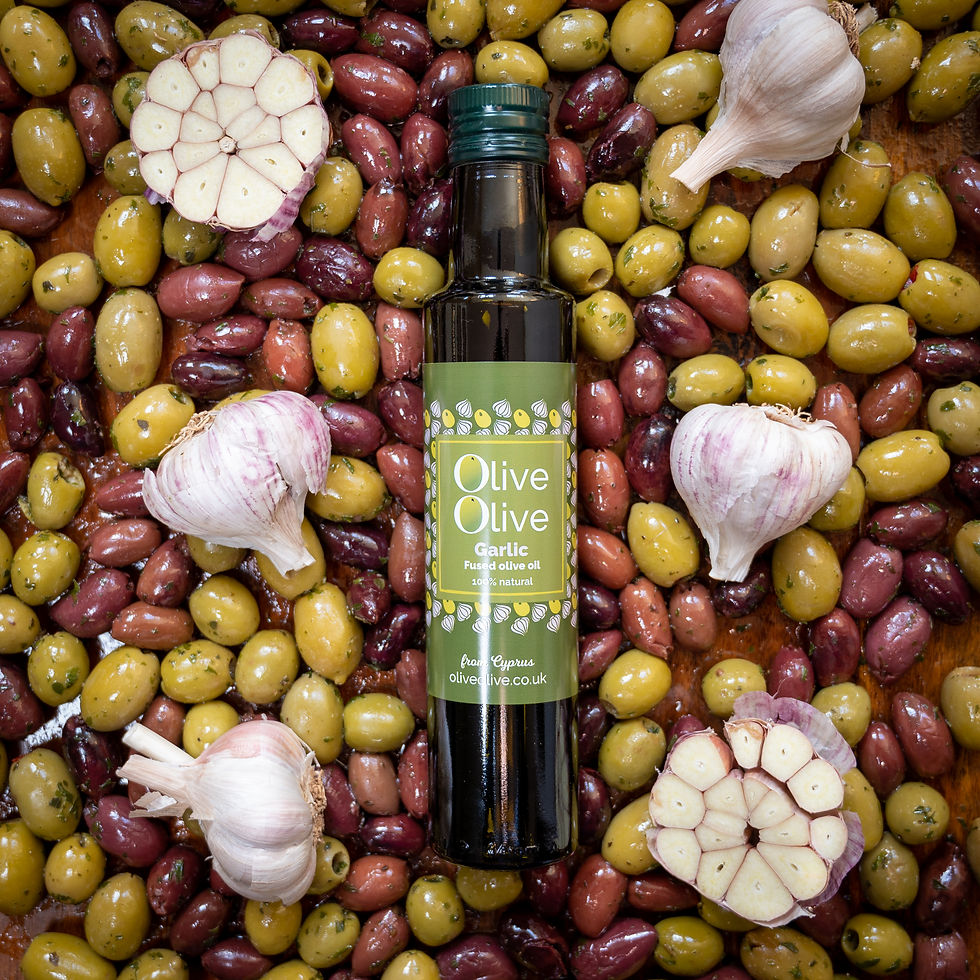 Thumbnail: Garlic fused olive oil from OliveOlive 250ml bottle lying on a bed of fresh olives and chunks of garlic