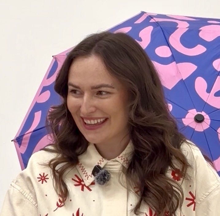 Female brand owner on set in the studio during a content day.