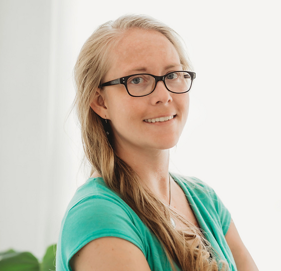 Professional headshot of a female Hypnotherapist with a friendly and confident smile.
