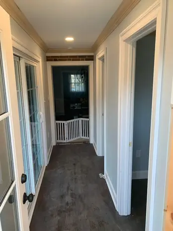 hallway with new doors and wood flooring