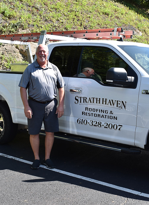 Jim Rothschild owner of Strath Haven Roofing & Restoration next to his work vehicle Villanova PA