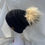Thumbnail: Black, knit hat with skunk Pompom