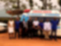 Group posing with ambulance, 'AMBULANCE FOR EMERGENCY 0710800000'