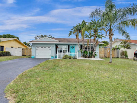 Front view of 3323 NW 68th Ct, a single-story home in Palm-Aire Village, Fort Lauderdale.