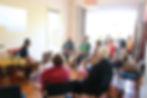 Speaker presenting to a group of listeners.