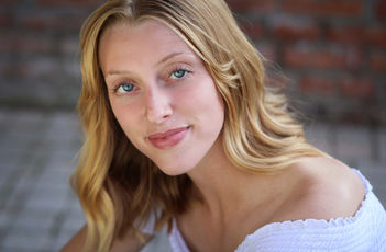 Woman wearing a white top (Headshot by Robin Buonomo of October Two)