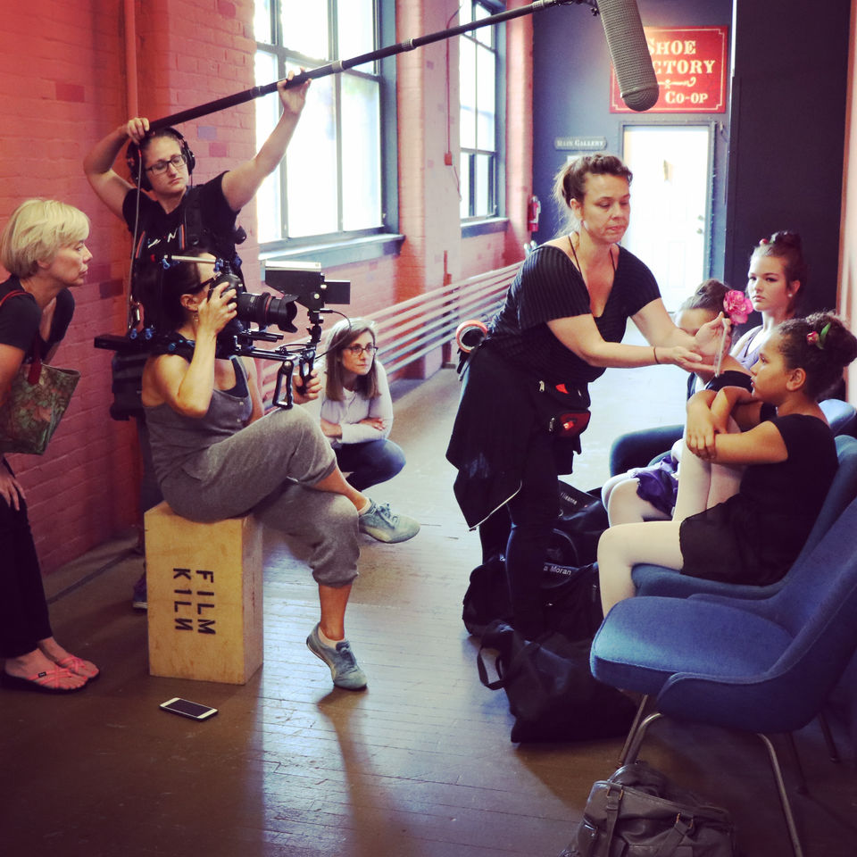 DP, Boom, and make up artist on set with actors.