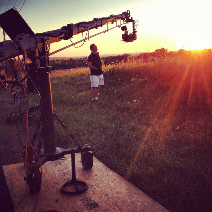 Crane shot in a field at sunset.