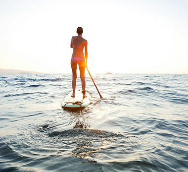 Girl on SUP at sunset