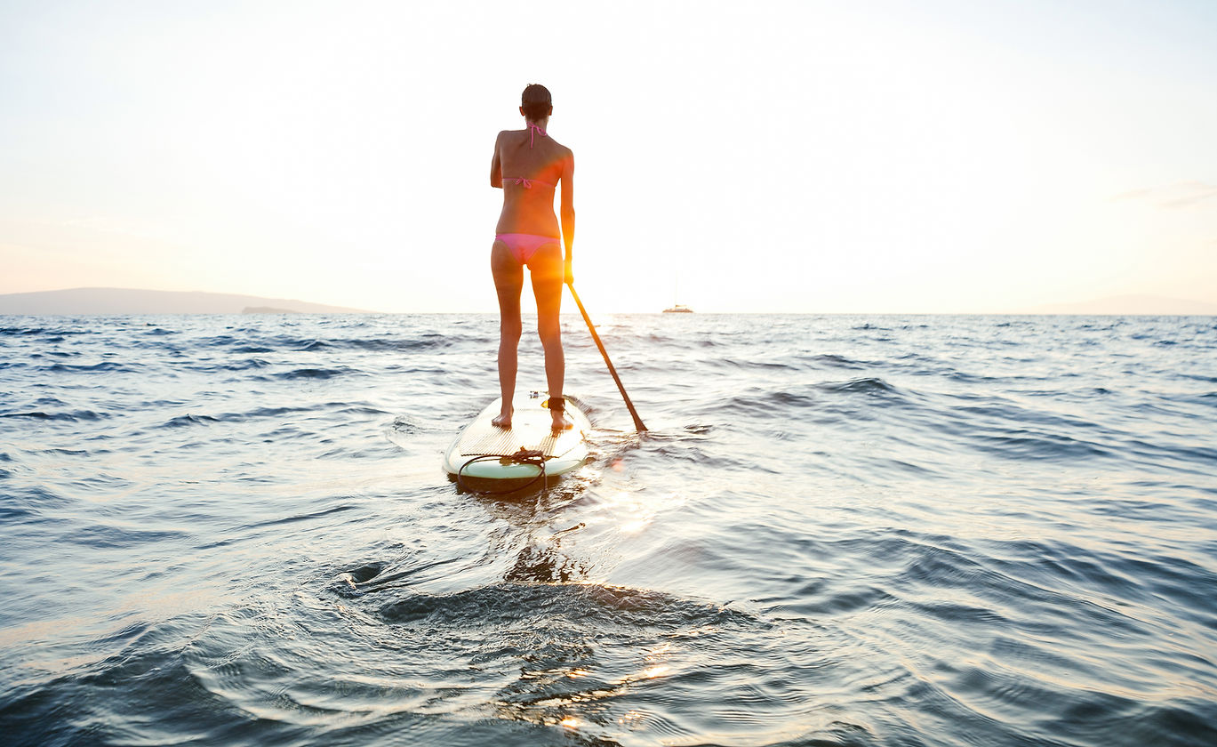 Girl on SUP at sunset