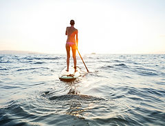 Girl on SUP at sunset