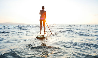Girl on SUP at sunset