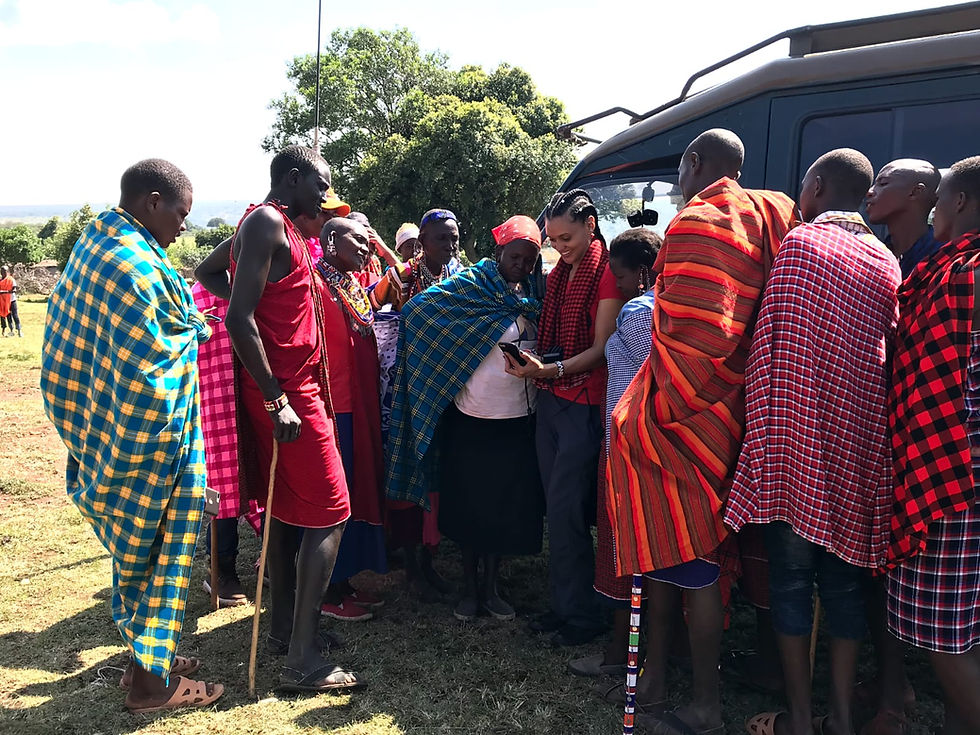 village members viewing photos and videos on a cell phone