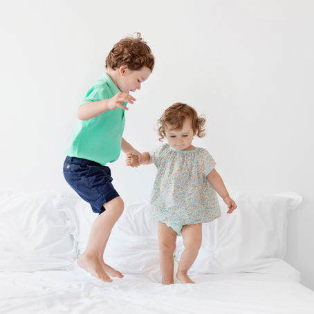 Kids jumping on the bed.