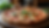 Eye-level view of a delicious homemade pizza on a rustic wooden table