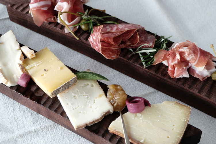 Savour local cheese and salami, served on boards made by local designer, Riccardo Monte.