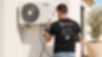 Technician checking an outdoor air conditioning unit with pressure gauges.