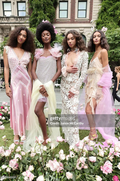 Group of models in pastel and floral outfits from Love Shack Fancy's collection, all showcasing refined nude manicures by Sofie Roth
