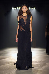 Model in a black sleeveless gown with a flowing silhouette from Jason Wu's collection, showcasing a clean nude manicure by Sofie Roth
