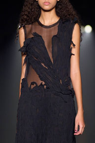 Close-up of a black lace dress with floral accents from Jason Wu's collection, styled with a soft nude manicure by Sofie Roth
