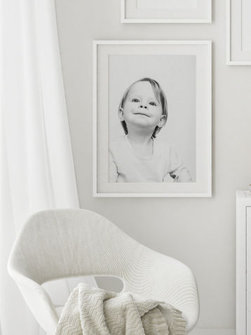 Sweet little girl in framed photo in white cozy room