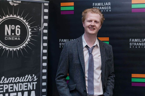 man stands outside cinema premiere