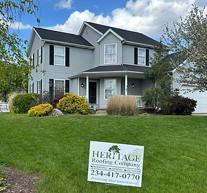 New black GAF Timberline HDZ thirty year shingle installation with Heritage Roofing Company sign in the front yard Lousville