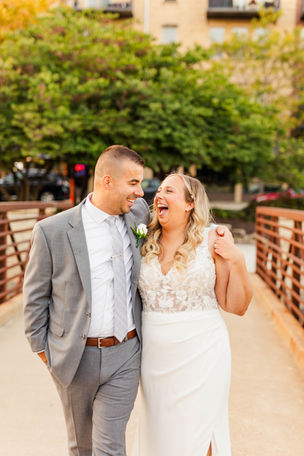 bride and groom at golden hour on the pedestrian bridge in downtown lemont