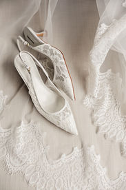 brides lace shoes on a lace veil
