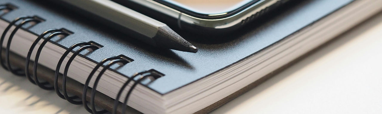 Phone and pencil on a notebook