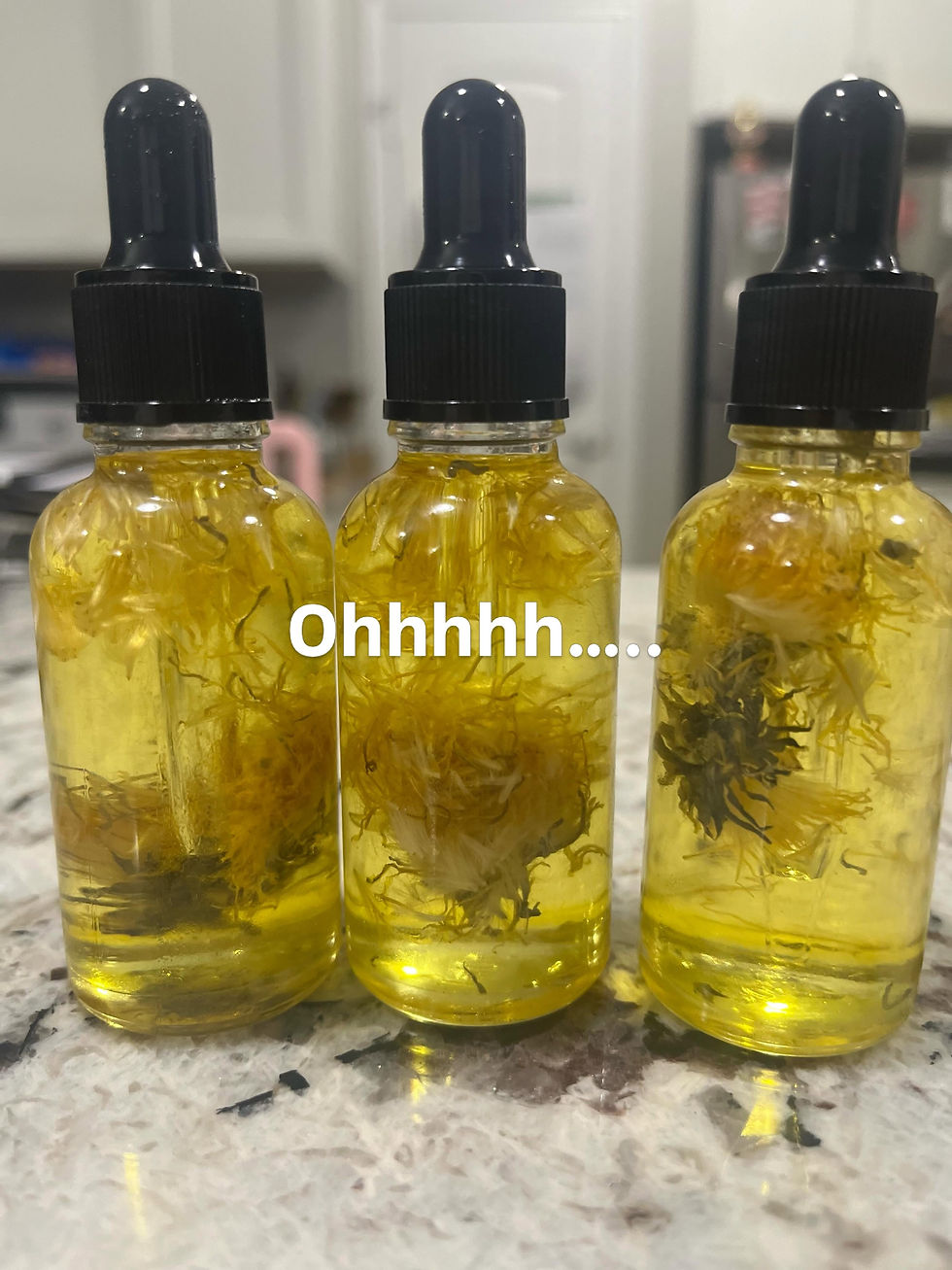 Thumbnail: Handcrafted Dandelion Infused Herbal Oil with real dandelion blossoms in a glass dropper bottle for botanical skincare