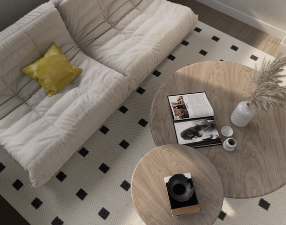 Inviting living room corner with a comfortable sofa, vibrant pillow, and a round wooden coffee table.