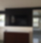 65 in. Samsung on accent wall. Equipment in cabinet to the left.