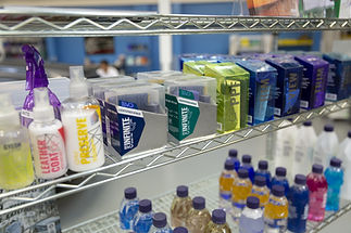 A shelf displaying a collection of Gyeon professional-only ceramic coatings and Gyeon aftercare products, demonstrating a commitment to the complete certified system, with the Immaculate Paint Protection logo visible in the background.