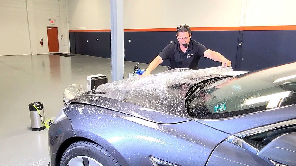 Paint Protection Film being installed on a Tesla Model S at Immaculate Paint Protection.