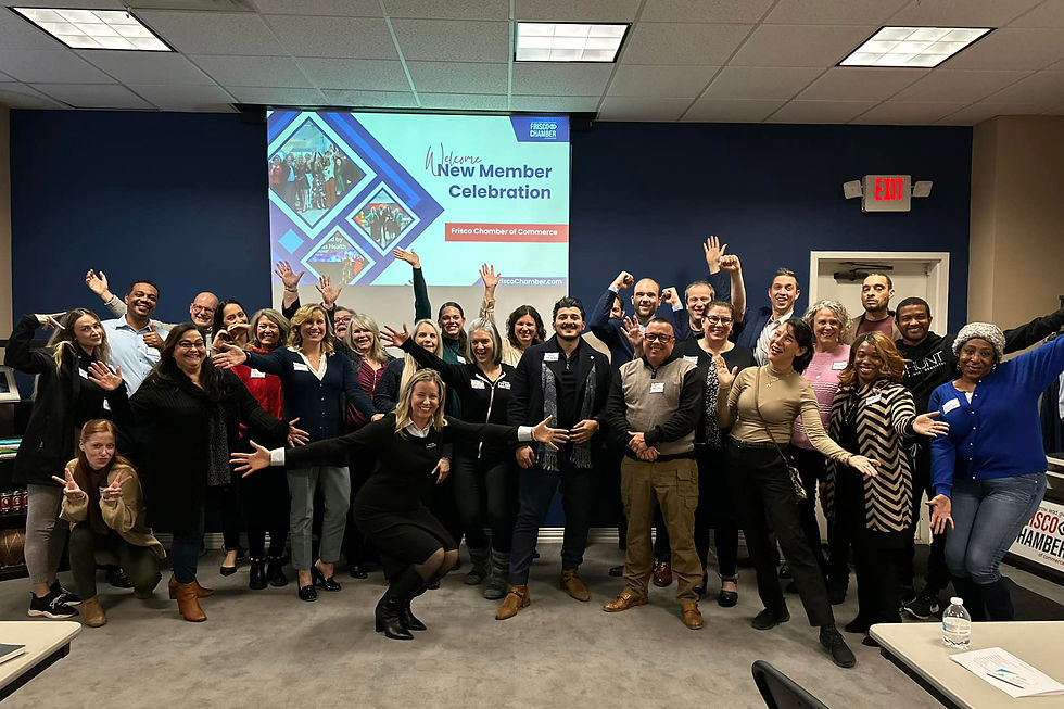 Group photo of Frisco Chamber of Commerce members celebrating at a New Member Celebration event, smiling and posing together in a conference room.