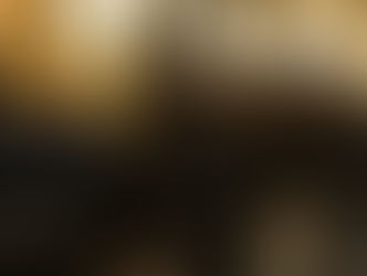 Black chairs meant for barber shop inside a barber shop, with low lighting