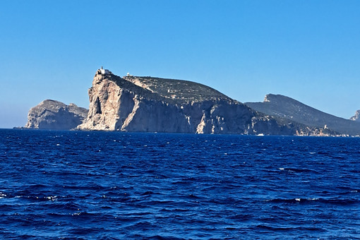 View of Capo Caccia while sailing past Porto Conte bay