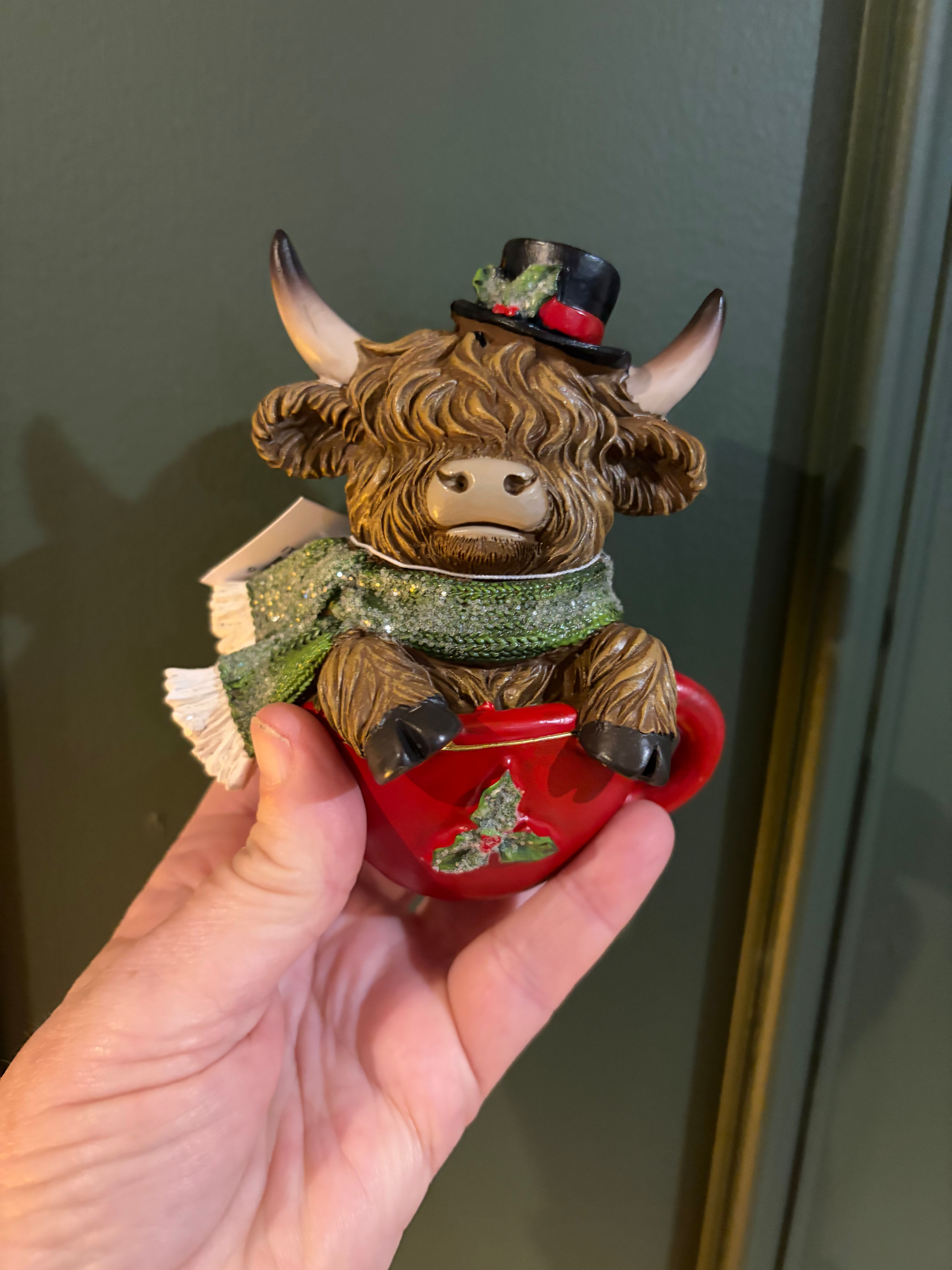 Christmas Highland Cow wearing a Christmas Top hat sitting in a red Cup Figurine