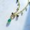 Thumbnail: Artistic sunlight left view product image of green onyx charm necklace.